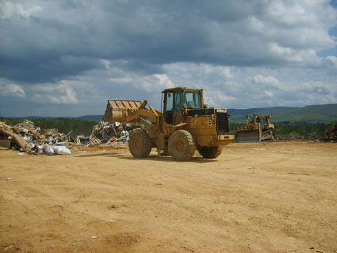 Cat tractor moving inert materials